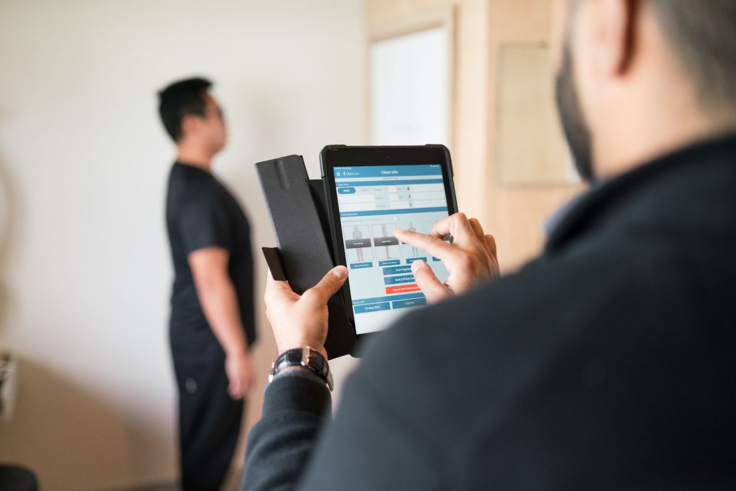 Chiropractor assessing spinal posture during a session in Mt. Eden